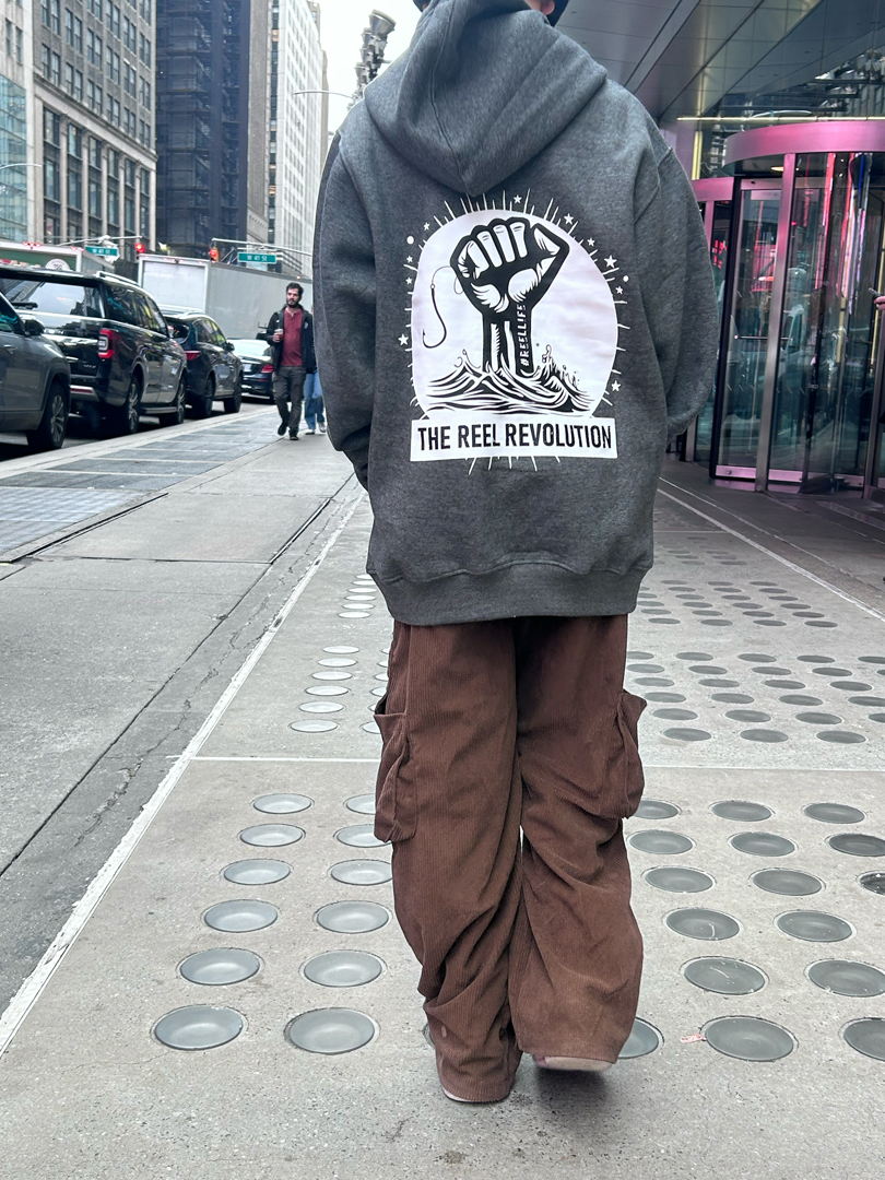 Reel Revolution sweatshirt in an urban coastal setting